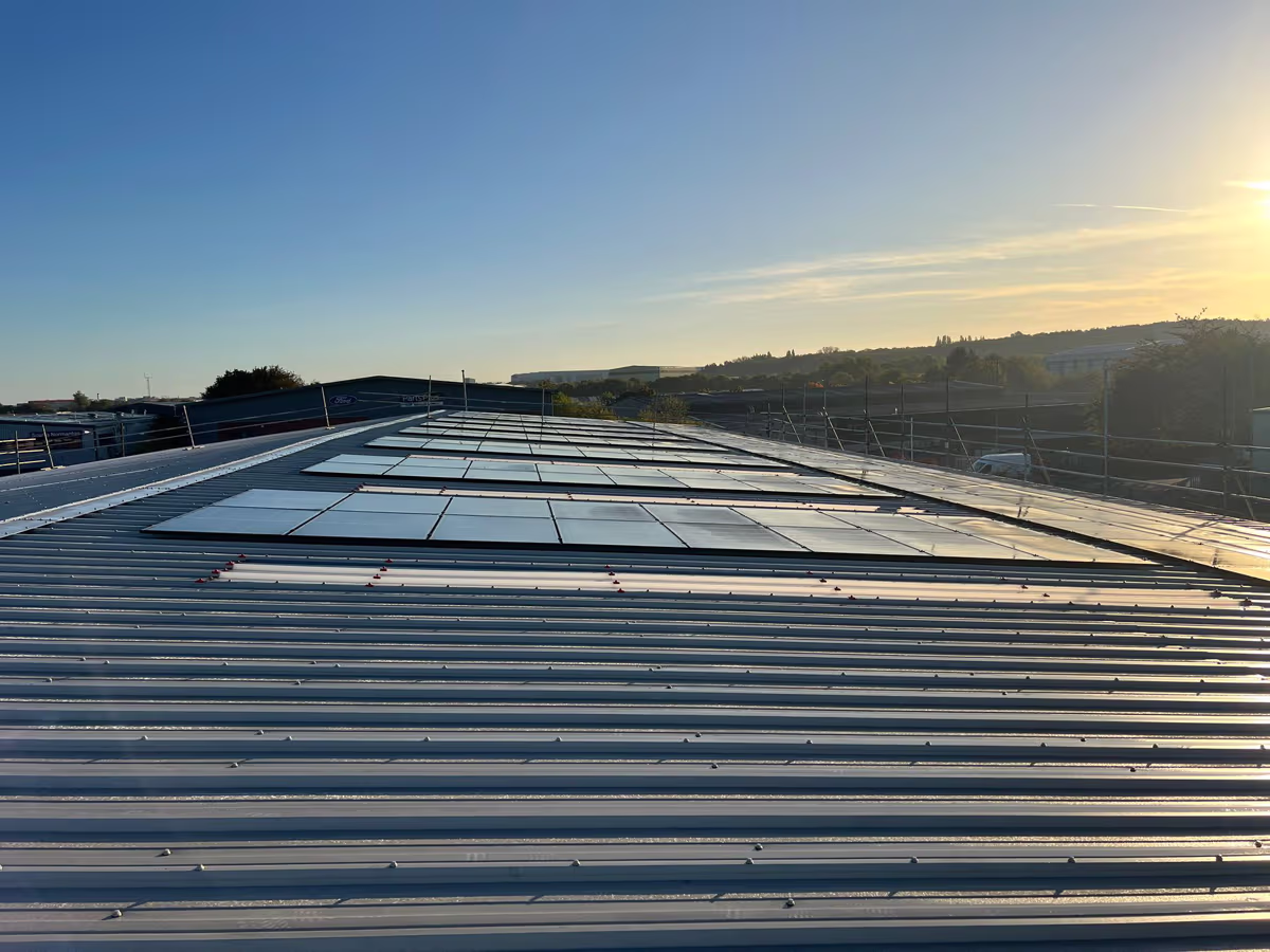 Roof-mounted solar array at sunrise installed by Renewable Leeds